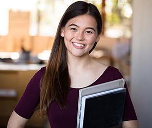 UB student holding books